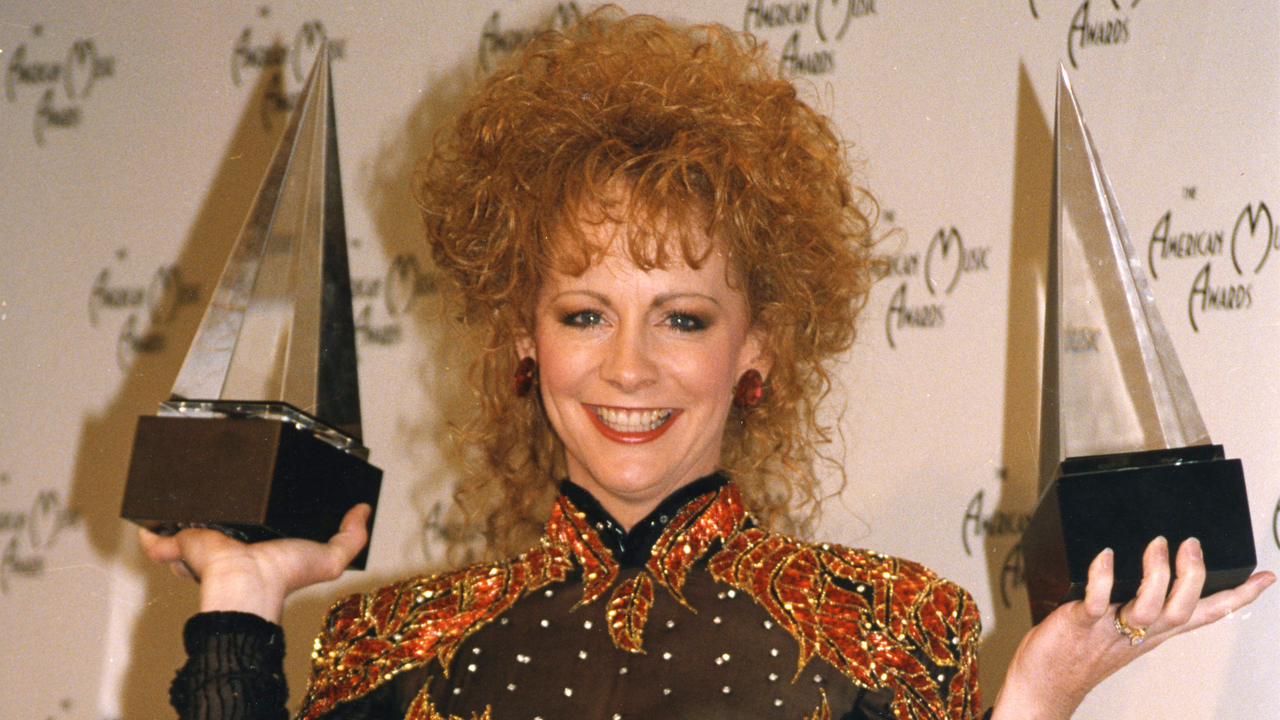 Reba holding awards 